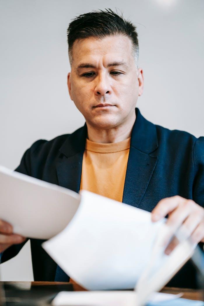 Photo of man reviewing paperworks 6325924.jpeg